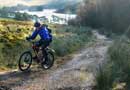 Mountain biker making his way across Pentland hills regional park